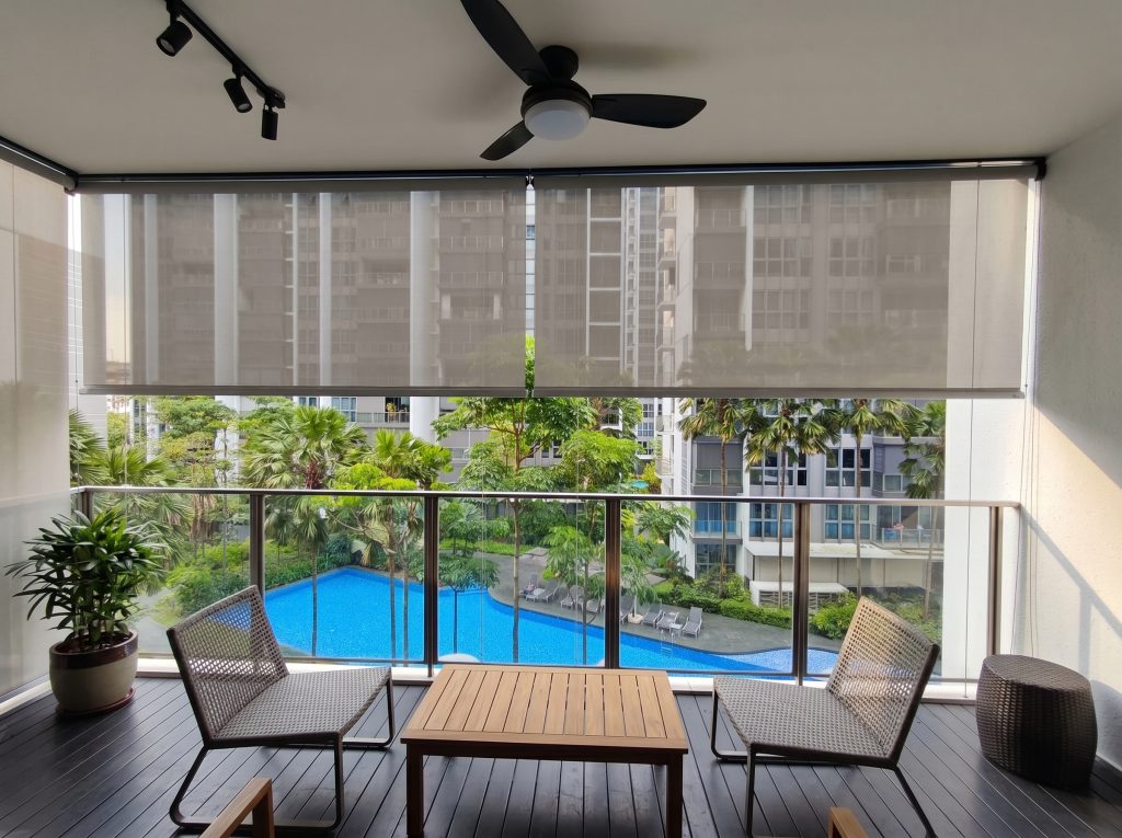 Contemporary grey weather-resistant roller shades for a high-rise Singapore condo balcony.