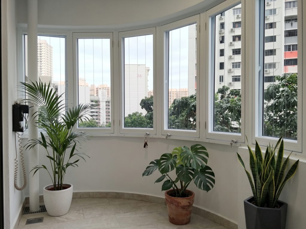 Casement invisible grille Singapore for a curved HDB balcony in Toa Payoh, ensuring safety and views.