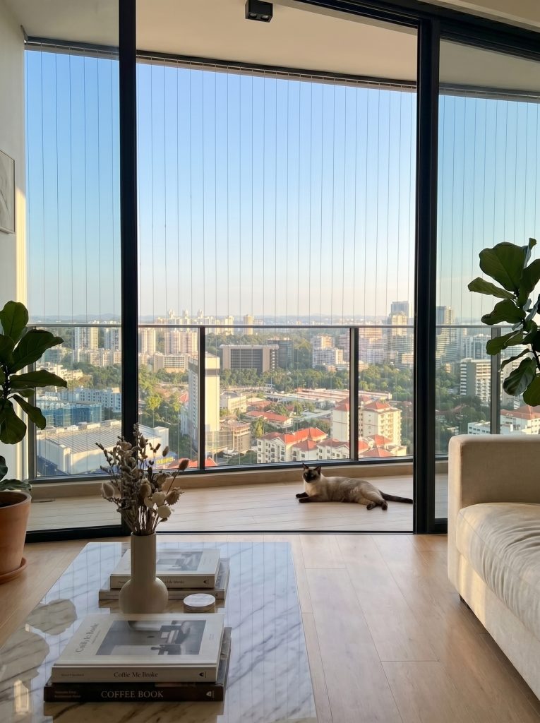 Invisible window grille Singapore with 2-inch spacing for pet safety on a high-rise condo balcony.