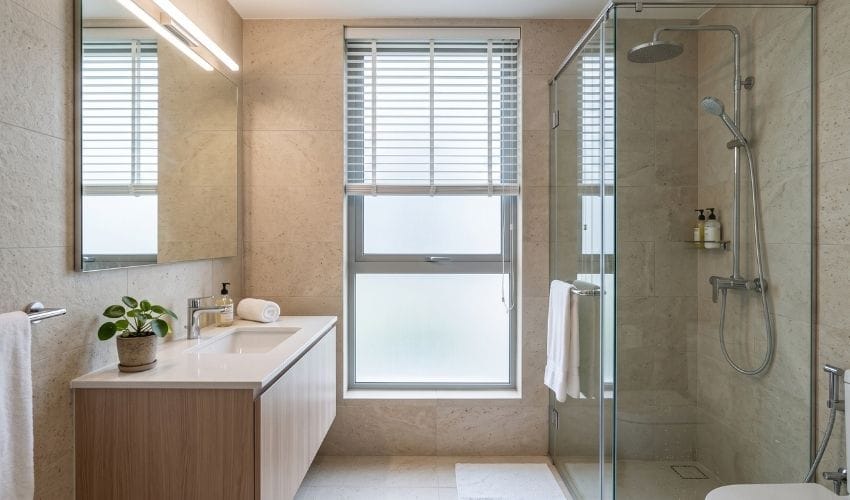White faux-wood Venetian blinds fitted in a humid Singapore HDB bathroom