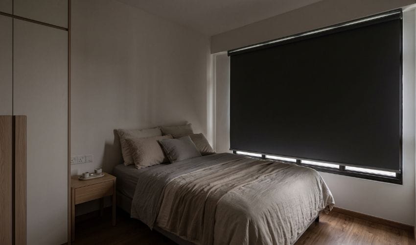 Motorised blackout roller blinds reducing morning light in a Punggol HDB bedroom Singapore